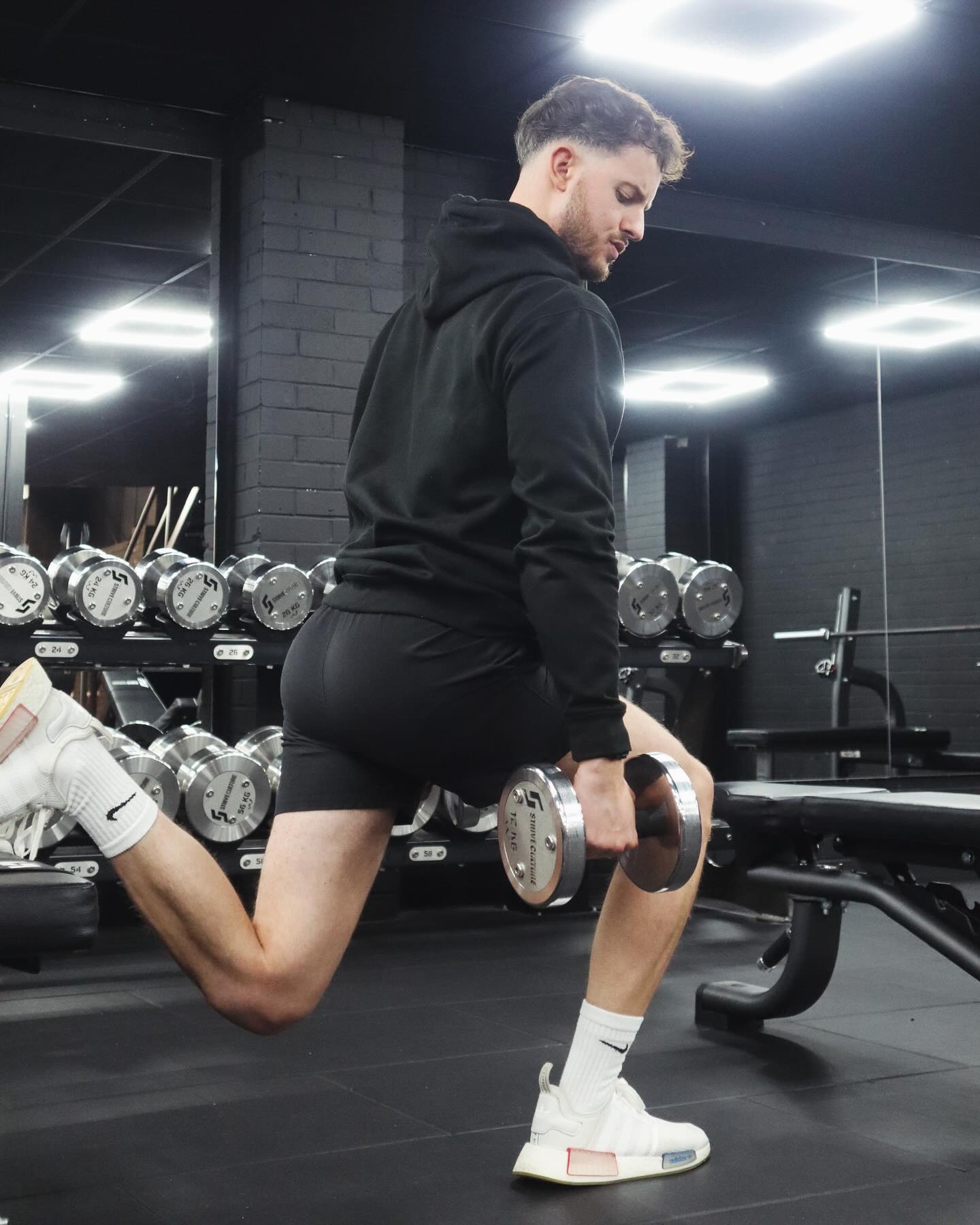 Sam Wilko performing a split squat with dumbbells