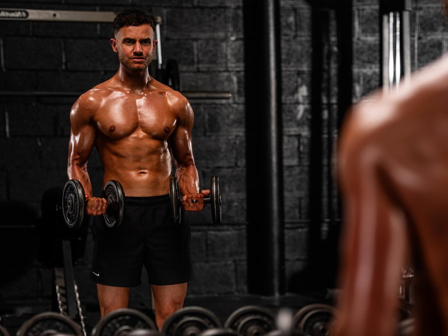 Sam Wilko training with dumbbells at the gym